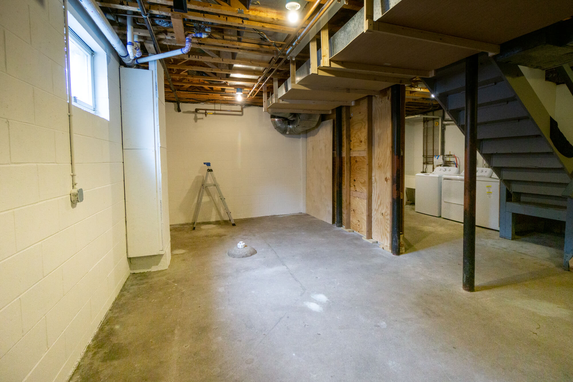 Basement with window on the left and laundry on the right.