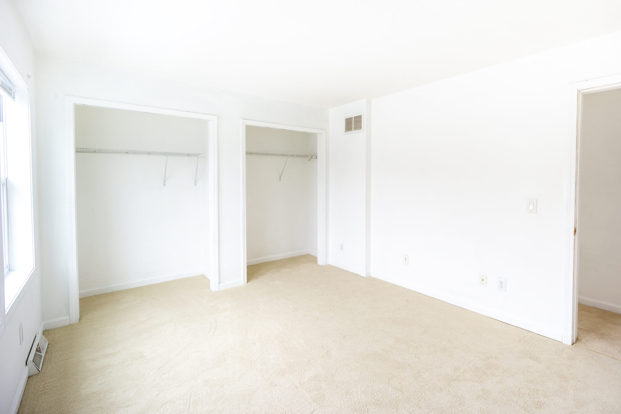 Second floor double bedroom facing the closets and the door.